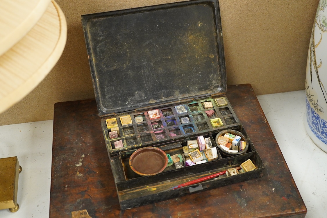 Three early to mid 20th century artist’s paint boxes, one tin box with Winsor and Newton label to the inside of the lid, plus a Rowley labelled box, a wooden paint box- 39cm wide, together with a leather pencil case, the